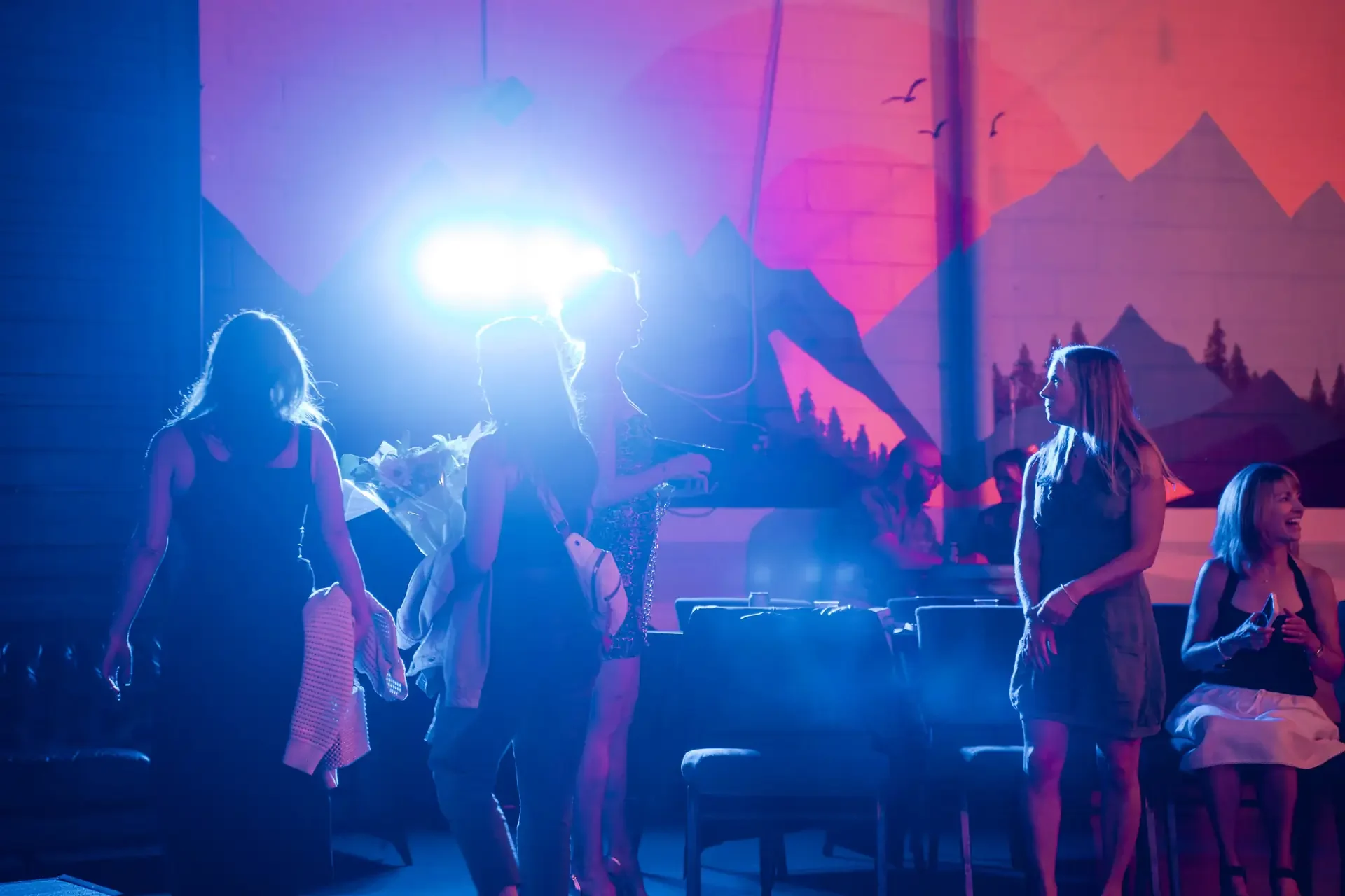 A live dance show lit in blue and pink