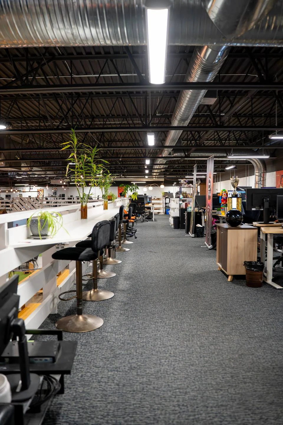Long rows of desks in a bright, open workspace