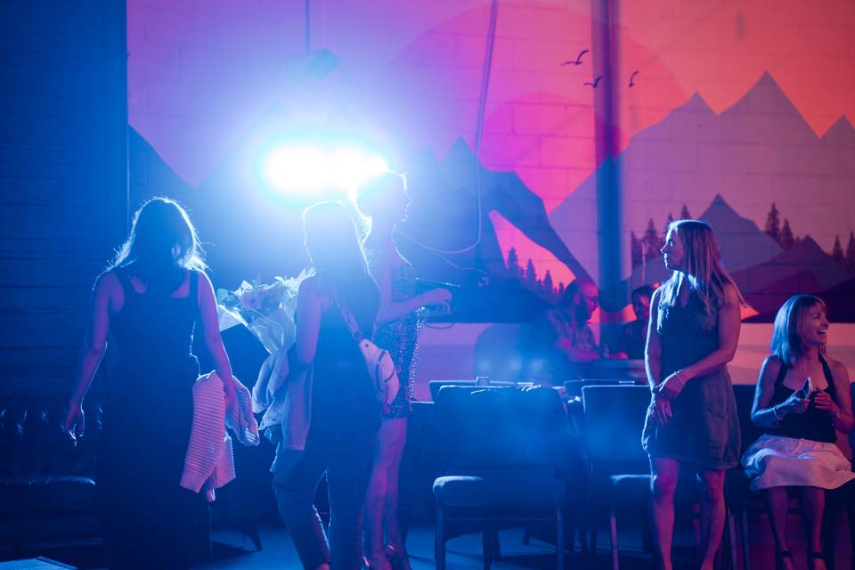 A live dance show lit in blue and pink