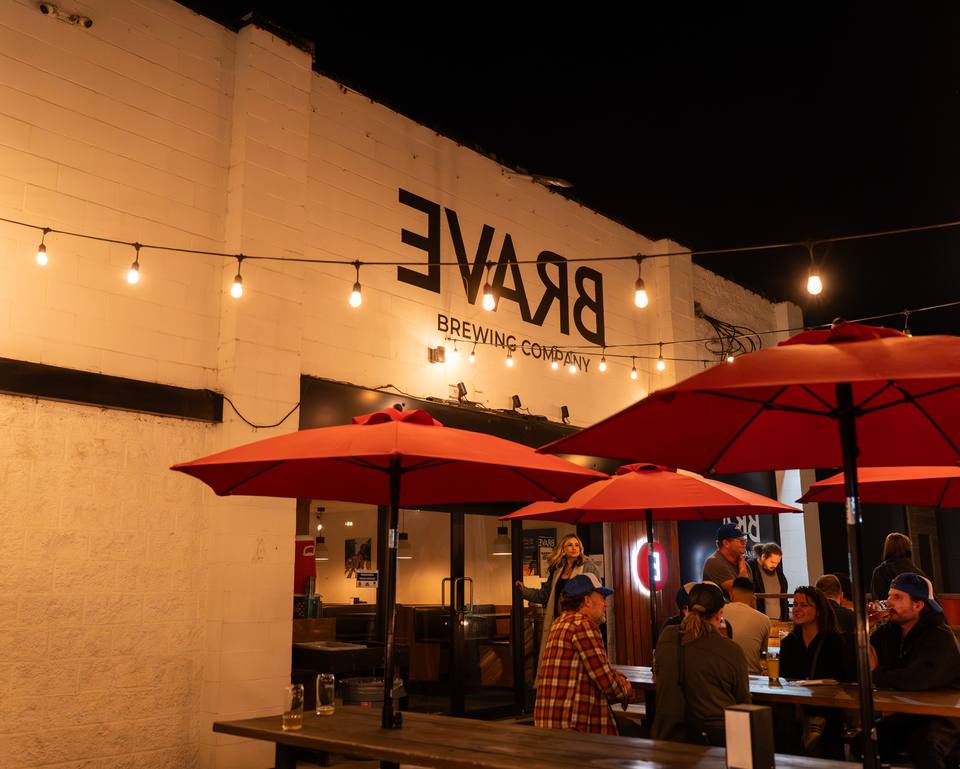 Brave Brewing patio at night under red umbrellas
