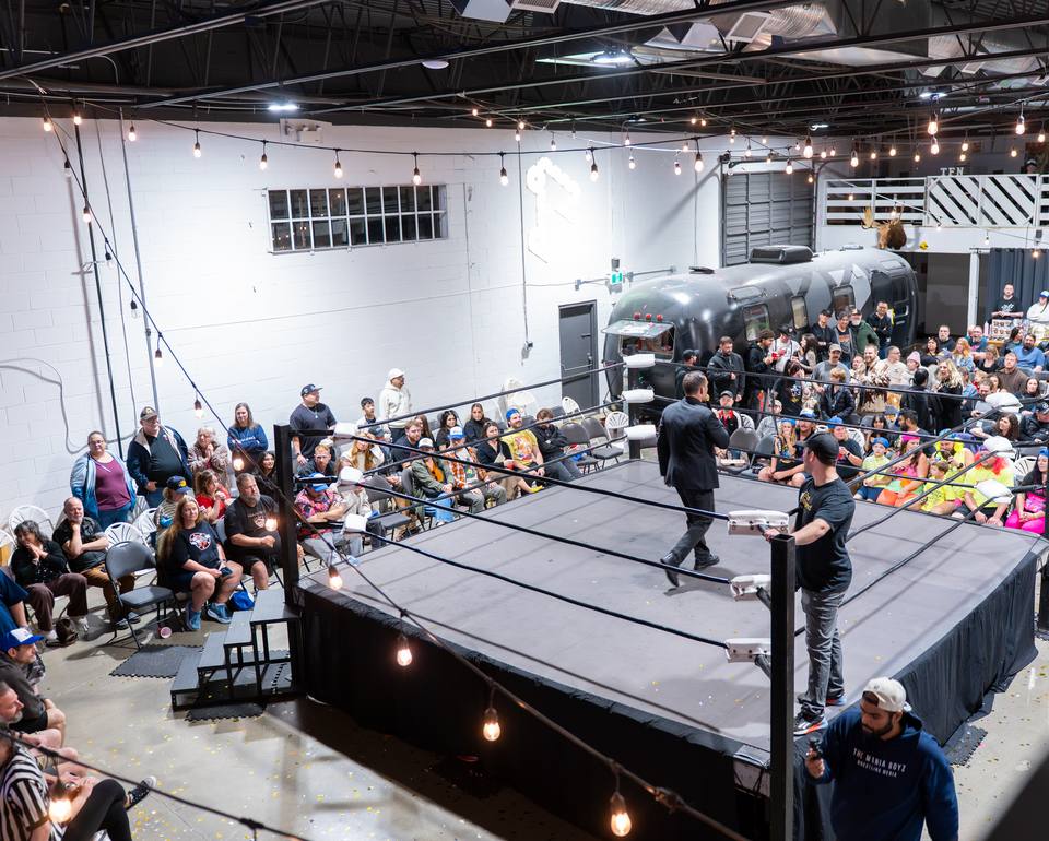 A packed crowd around a wrestling ring at Site B